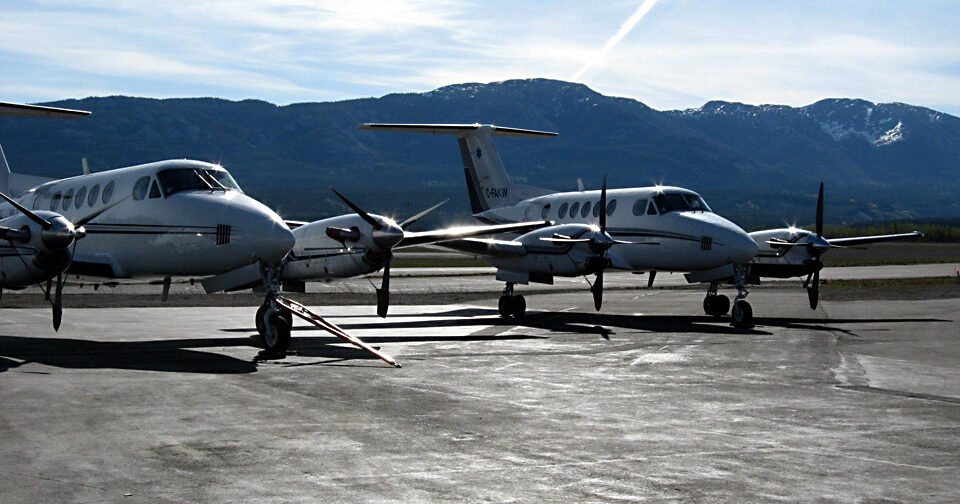 Two King Air 350 medevac aircraft on the tarmac, mountains in the background.