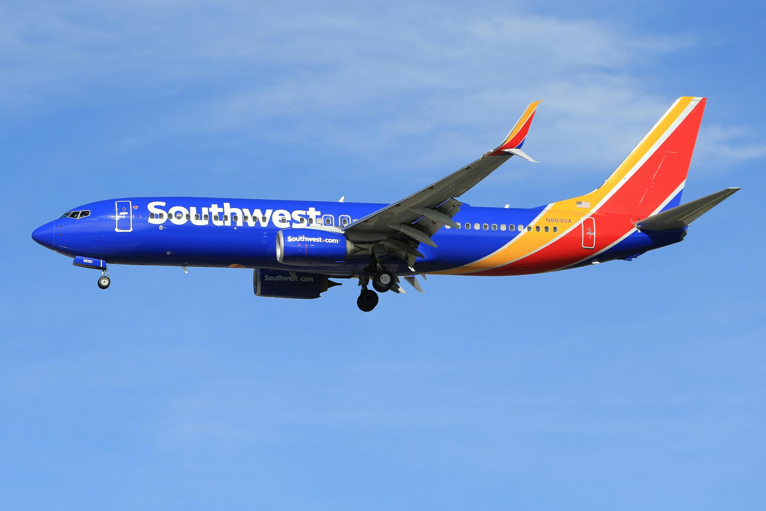 A Southwest Airlines plane during its flight, blue sky in background.