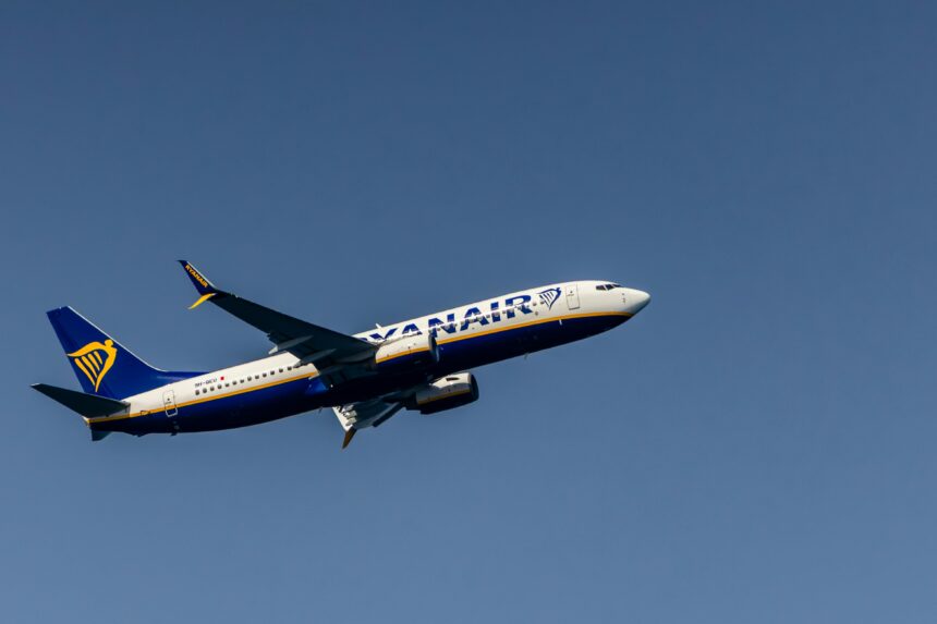 A large jetliner in flight in a blue sky