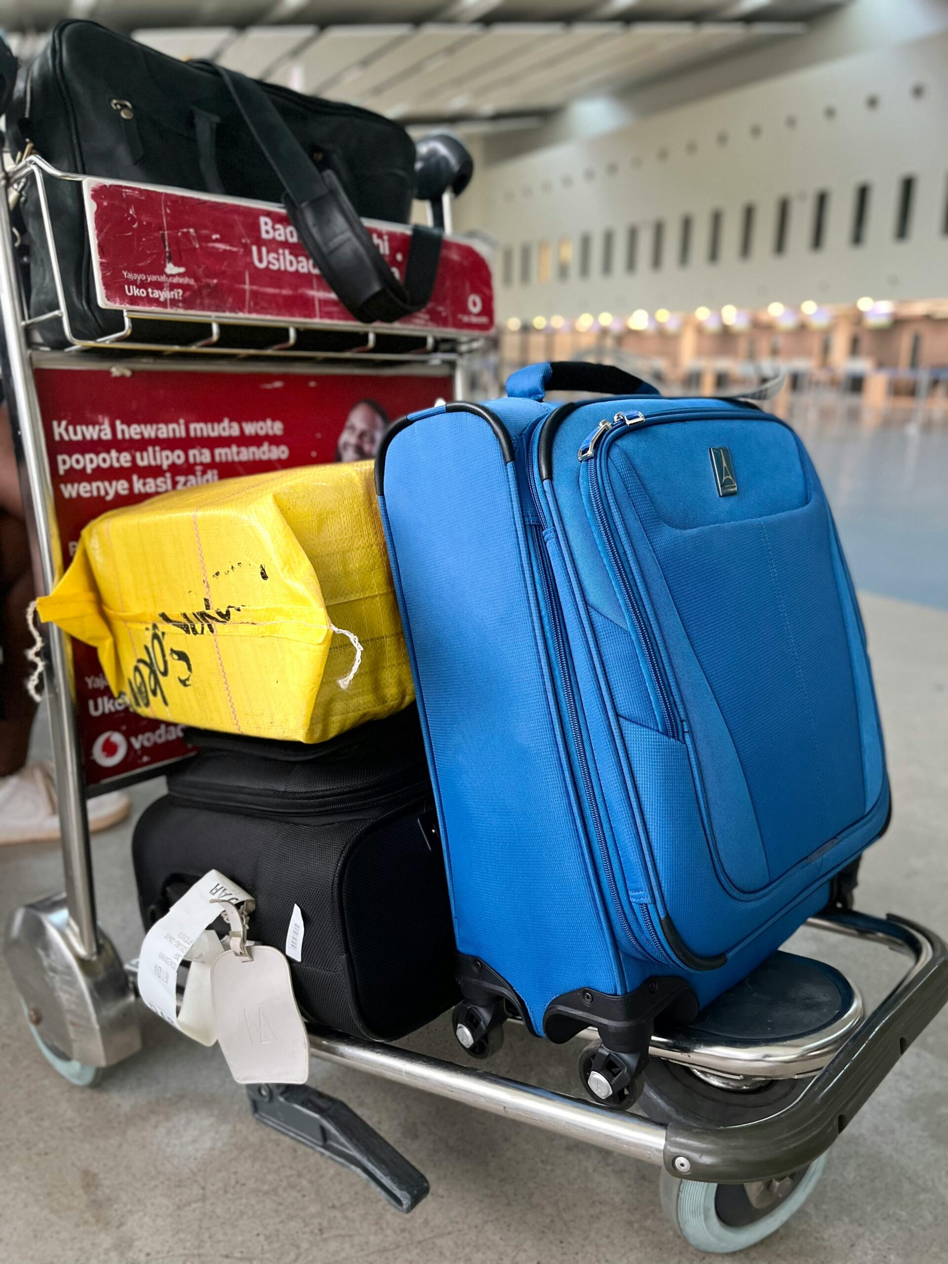 Suitcases on a luggage trolley at the airport.