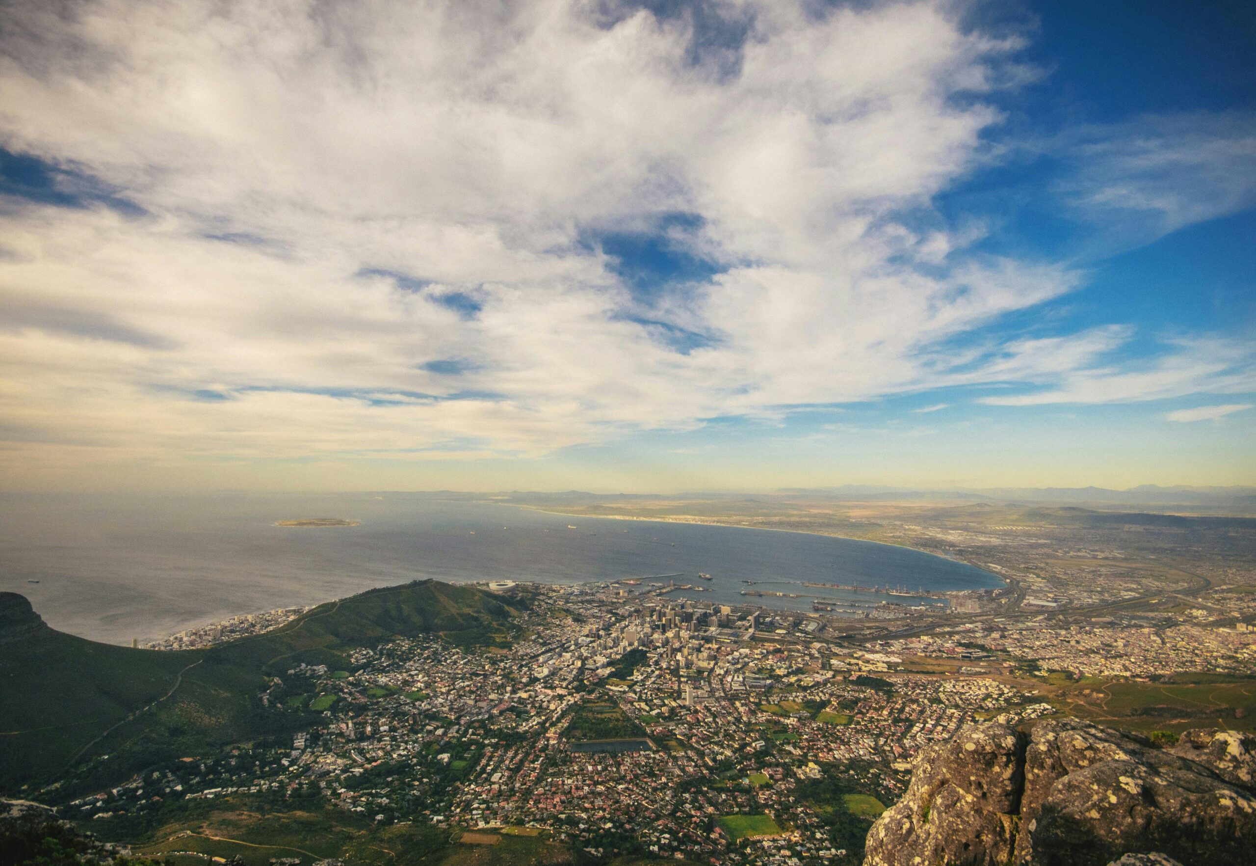 An aerial photo of an urban city under a blue sky