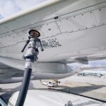 Preparations for an Airbus A320 to be refuelled on the tarmac.