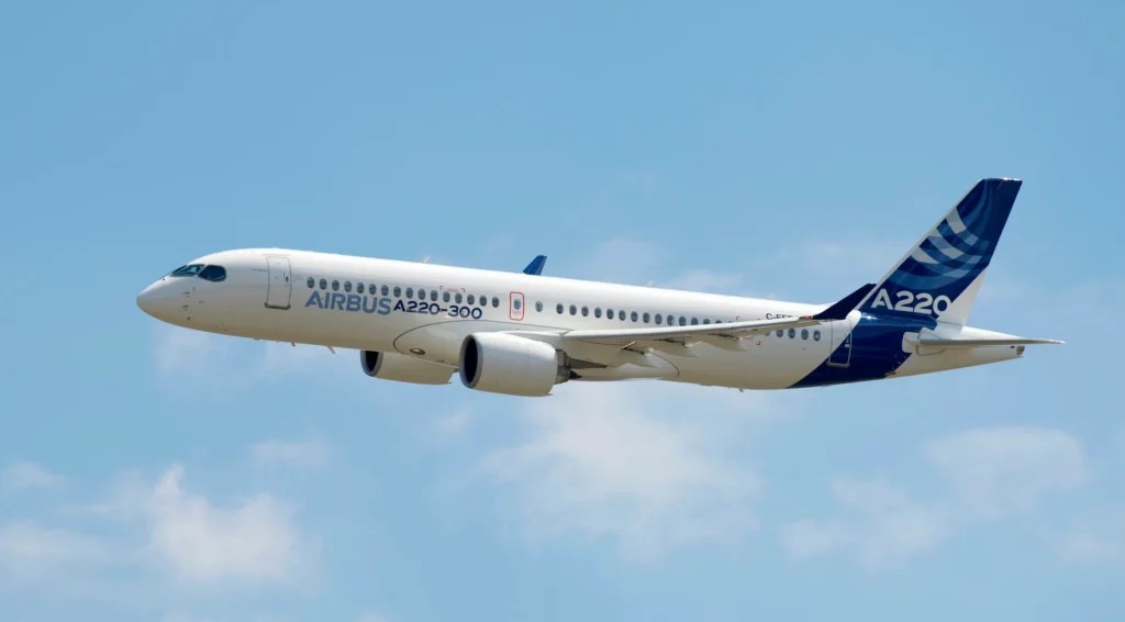 Airbus A220 aircraft flying in the blue sky.