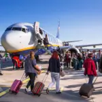 Numerous passengers boarding a Ryanair aircraft