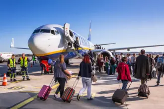 Numerous passengers boarding a Ryanair aircraft