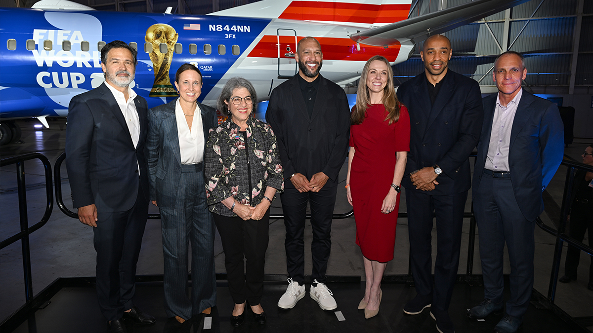 American Airlines Vice President of Miami Operations Juan Carlos Liscano, FIFA Chief Business and Strategy Officer Amy Hopfinger, Miami‑Dade County Mayor Daniella Levine Cava, Tim Howard, American Airlines Chief Marketing Officer and Senior Vice President of Communications Caroline Clayton, Thierry Henry, American Airlines Chief Commercial Officer Nat Pieper pose in front of American Airlines' FIFA World Cup 26-themed aircraft livery