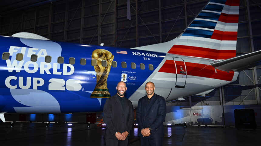 Tim Howard and Thierry Henry pose in front of American Airlines' FIFA World Cup 26-themed aircraft livery