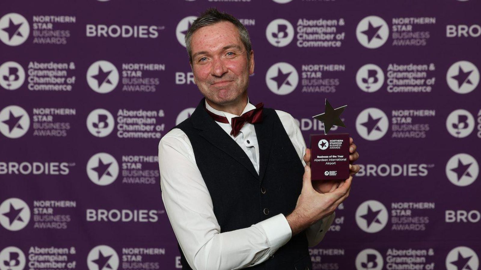 Aberdeen International Airport takes top prize at Northern Star Business Awards 2026. Man holding an award.
