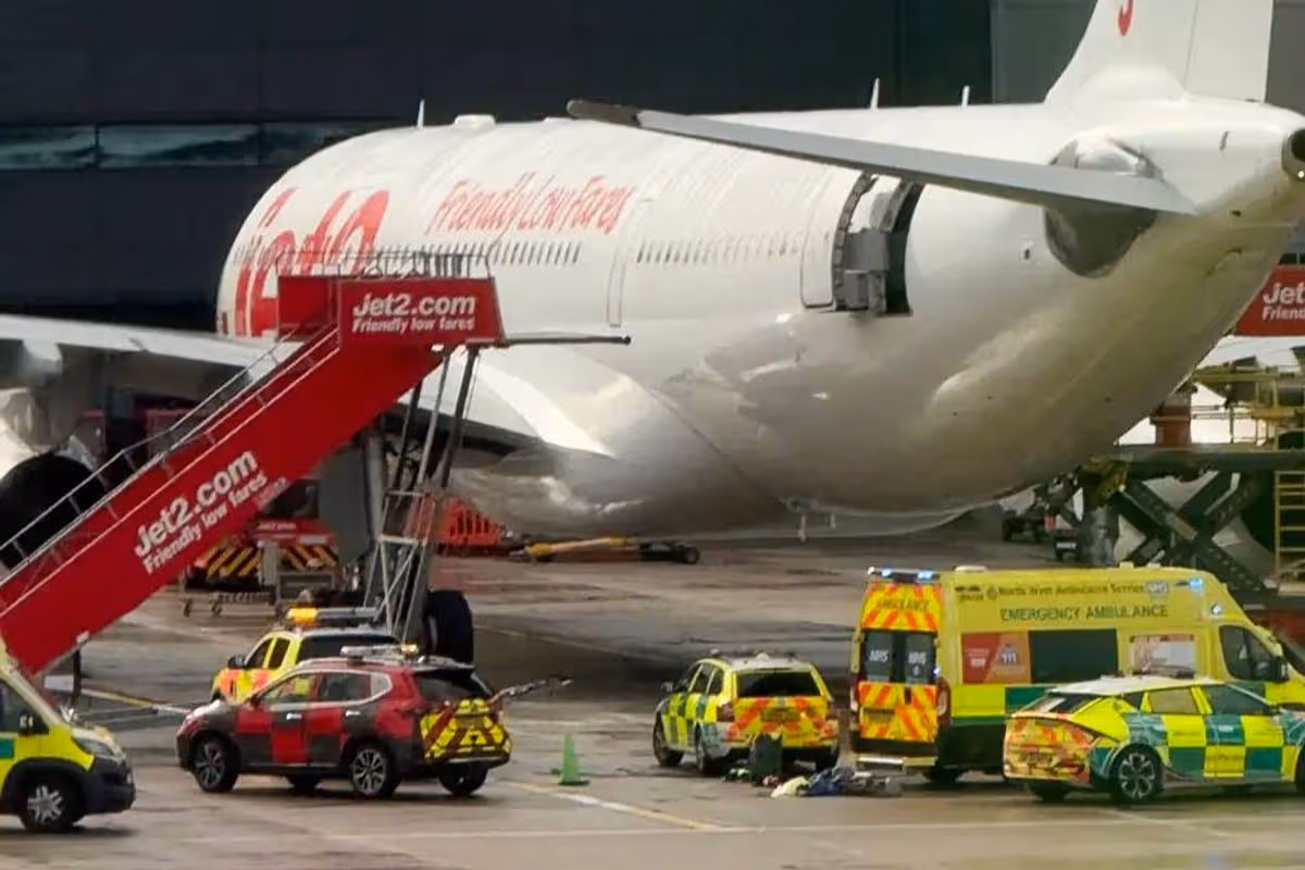 Jet2 aircraft with red stairs leading down from the aircraft and ambulances and fire vehicles surrounding the outside.