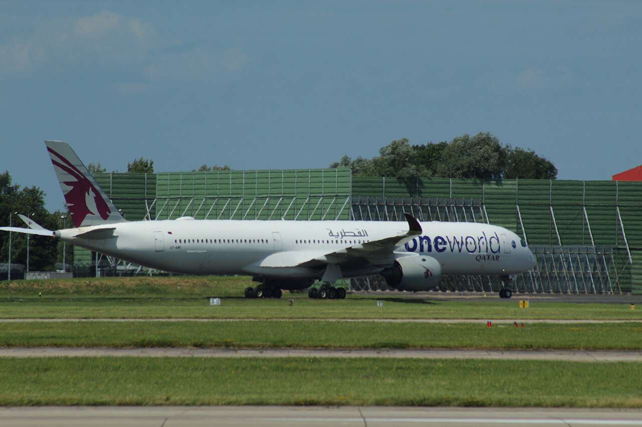 Qatar Airways A350 after landing in Manchester Airport. White and blue livery with red symbol on the tail.