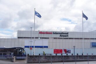 Aberdeen International Airport from the outside parking lot. There is a bus on the left hand side.