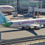 Caribbean Airlines Boeing 737-8Q8 pushing back from Terminal 4, JFK Airport, New York.