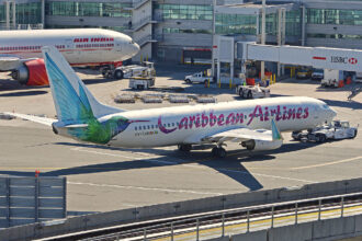 Caribbean Airlines Boeing 737-8Q8 pushing back from Terminal 4, JFK Airport, New York.