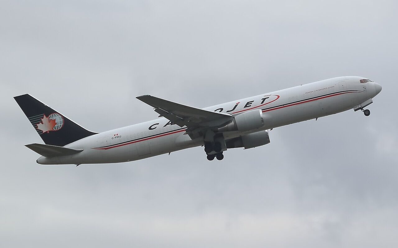Cargojet Boeing 767F C-FDIJ aircraft flying in the grey sky.