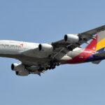 Asiana Airlines, subsidiary of Korean Air, A380 flying under a blue sky.