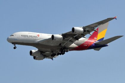 Asiana Airlines, subsidiary of Korean Air, A380 flying under a blue sky.