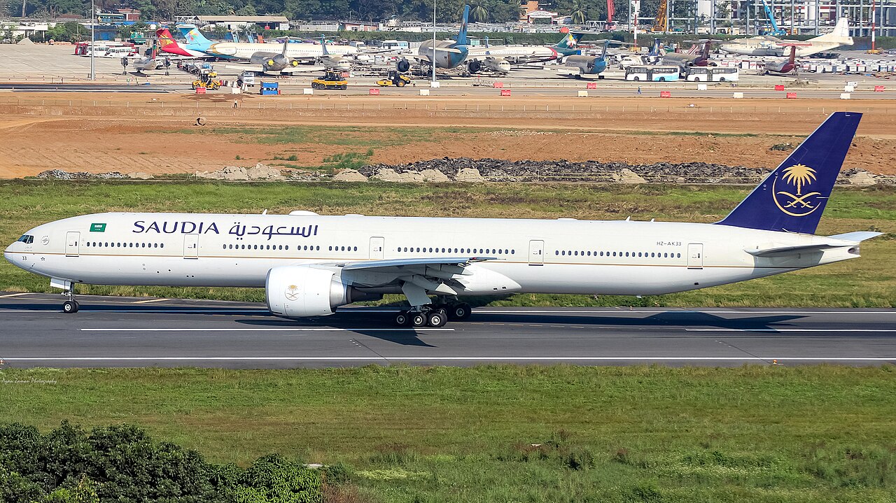 White and Blue Saudia Boeing 777 on the runway. 