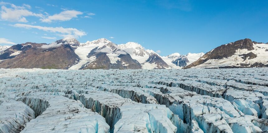 Mountain landscape in Chugach State Park, Alaska, featuring forested valleys and steep rocky hillsides.