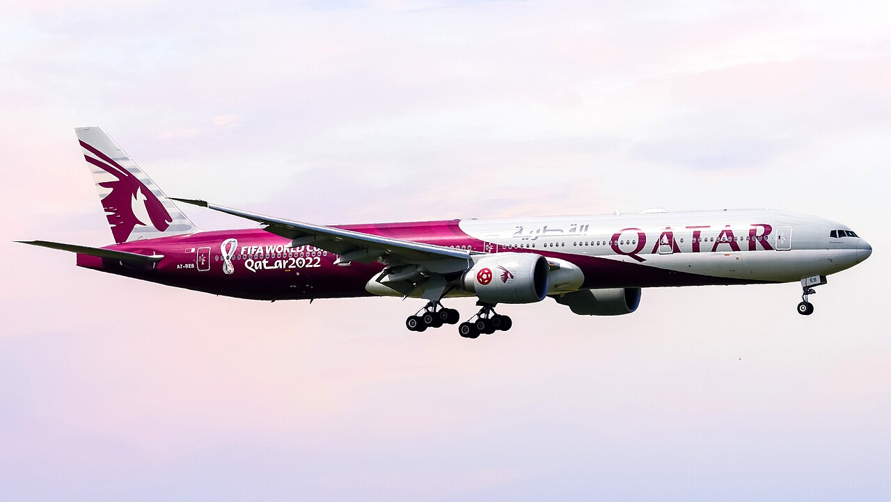 A World Cup 2022 Qatar Airways plane in red and white.
