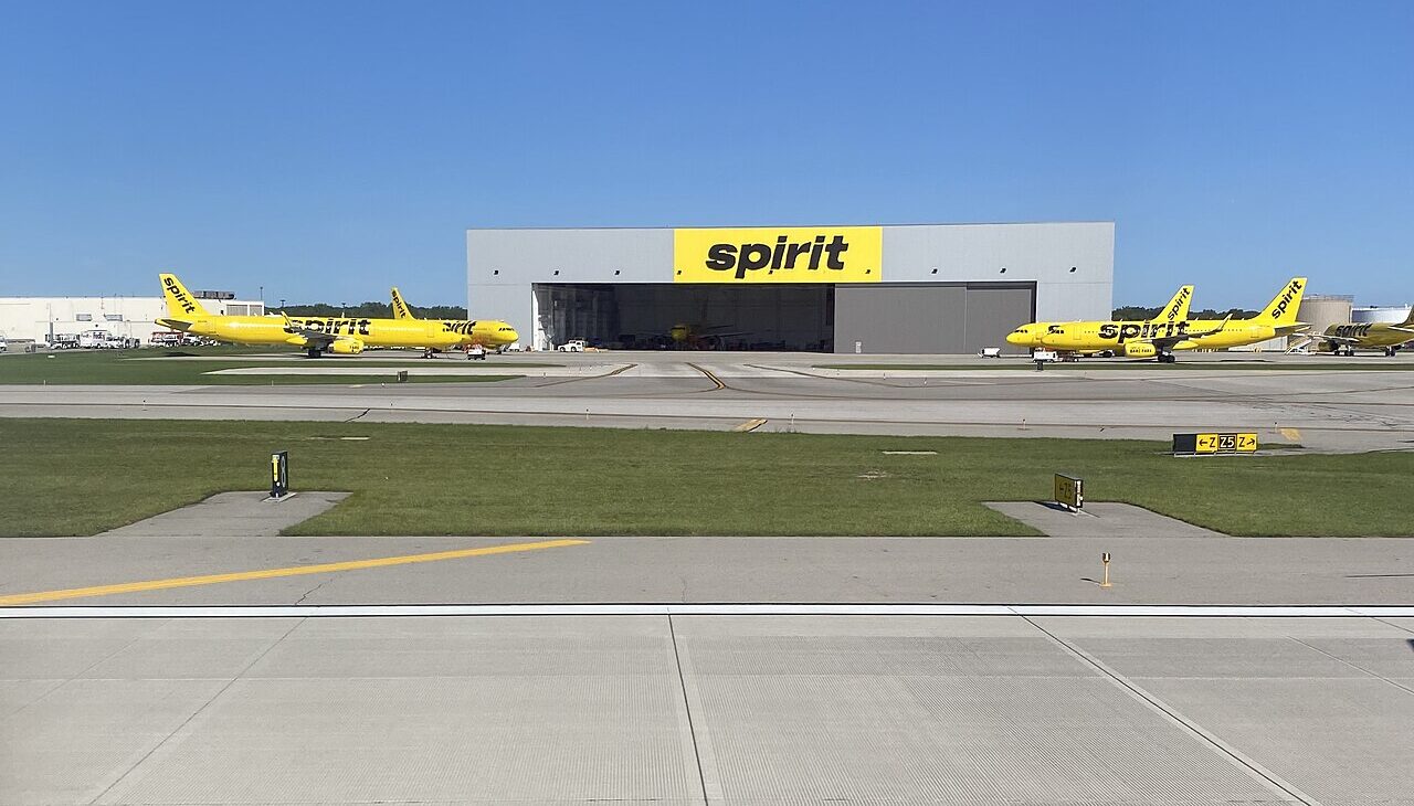 Spirit Airlines' maintenance hangar at Detroit Metro Airport (DTW) in front of a sunny sky