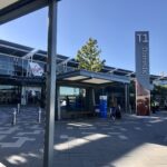 The entrance of Terminal One at Perth Airport, taken in 2022. It is a bright day with blue sky in the background.