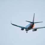Airbus A330 in flight with clear blue skies, decending for landing.