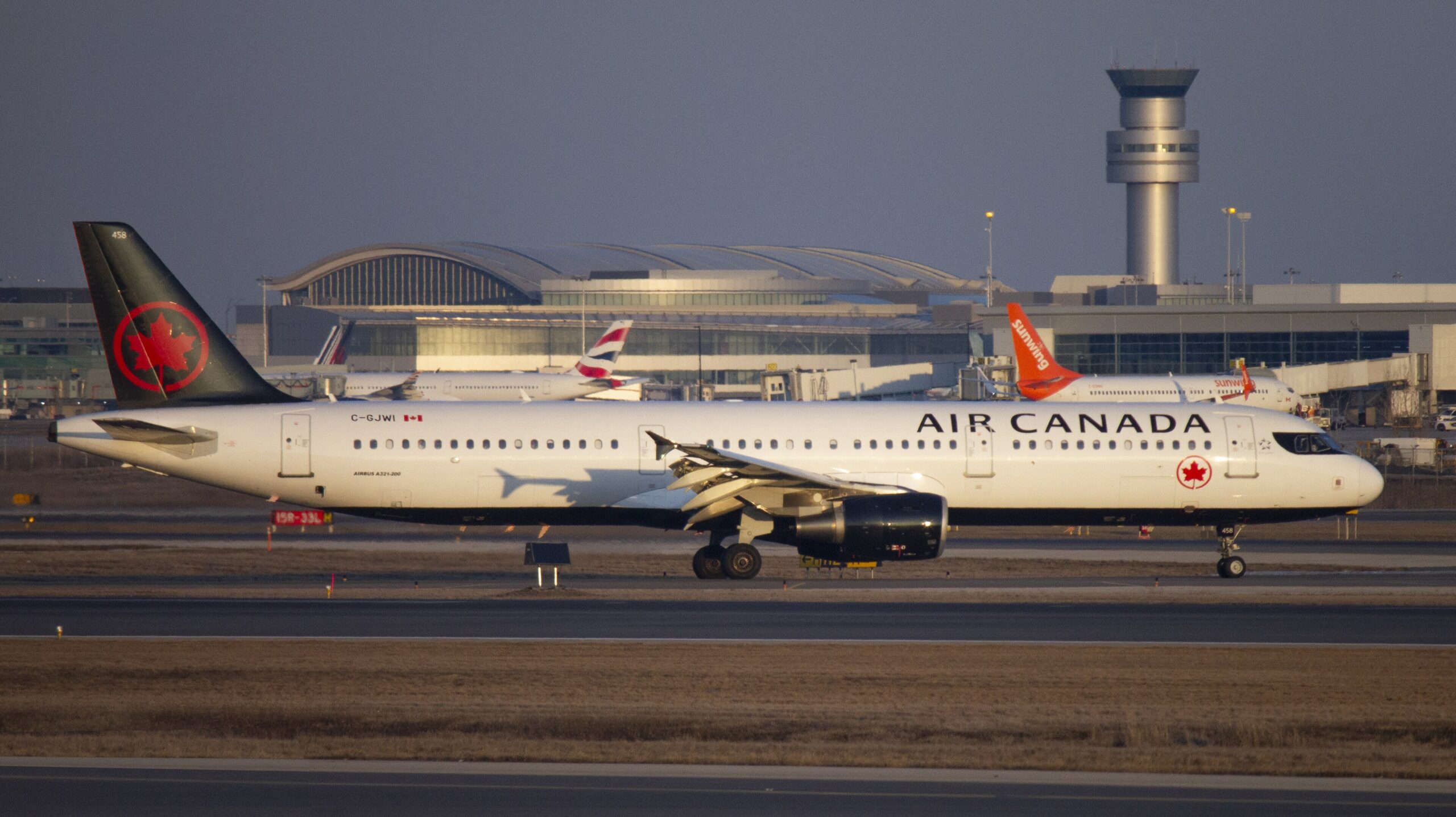 Air Canada Airbus A321 on the runway with Toronto Pearson International Airport in the background