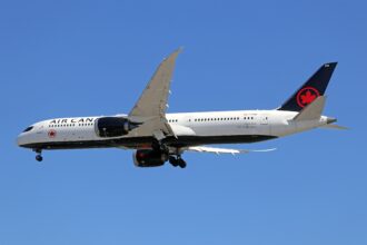 Air Canada B787-9 flying against a clear, blue sky