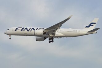 Finnair Airbus A350 flying against a clear, blue sky