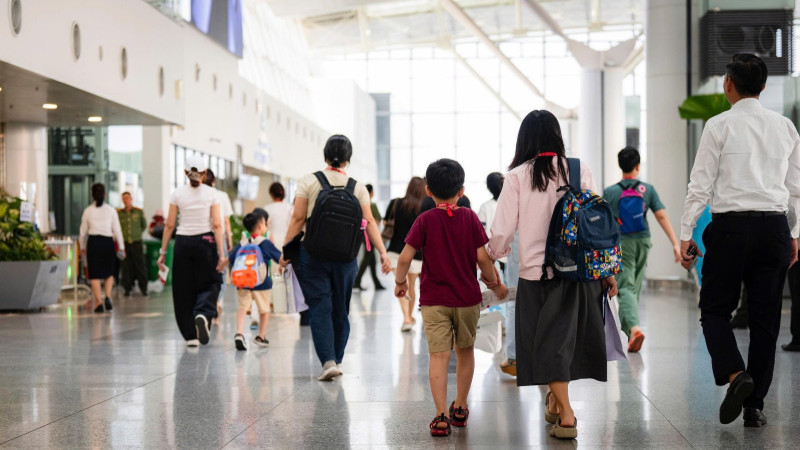 A group of participants passing through the airport