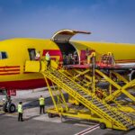 Cargo is being transferred to a DHL cargo aircraft