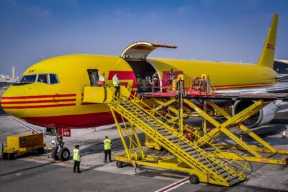 Cargo is being transferred to a DHL cargo aircraft