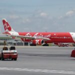 Airbus A330-200 F-GZCP aircraft at Lumpur Airport on the tarmac before takeoff. White and red livery.
