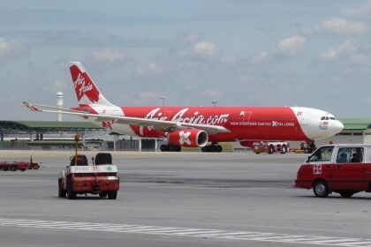 Airbus A330-200 F-GZCP aircraft at Lumpur Airport on the tarmac before takeoff. White and red livery.