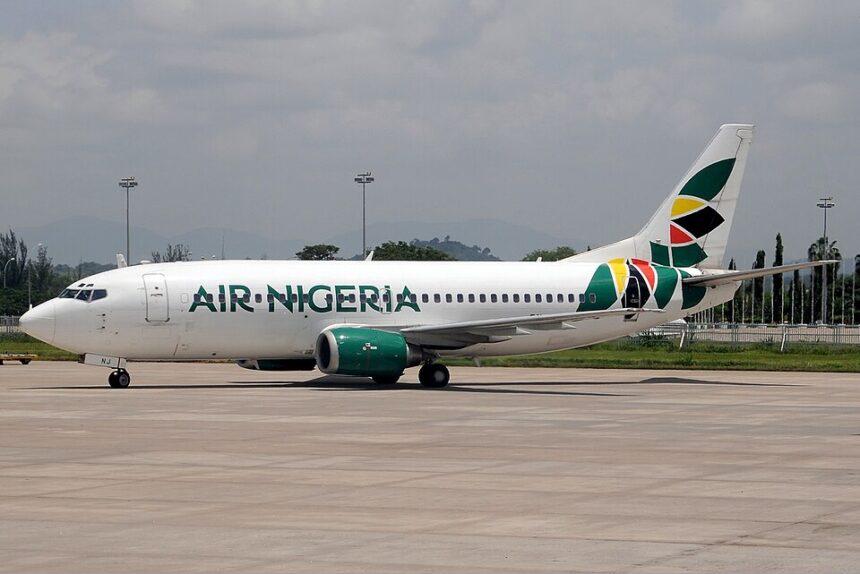 An Air Nigeria Boeing 737-300 aircraft captured on the airport tarmac, featuring its Air Nigeria branding and signature colorful tail.
