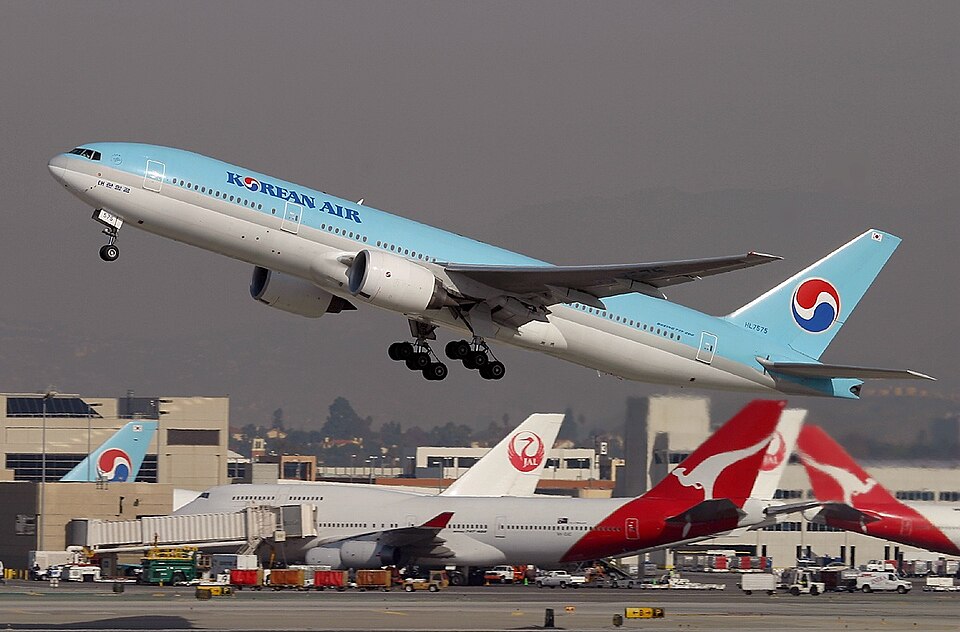 Korean Air Boeing 777 taking off against a cloudy sky 