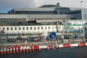 A high-angle view of Hangar 4 at Dublin Airport, showing the large-scale industrial architecture of the aircraft maintenance facility during a period of infrastructure upgrades.