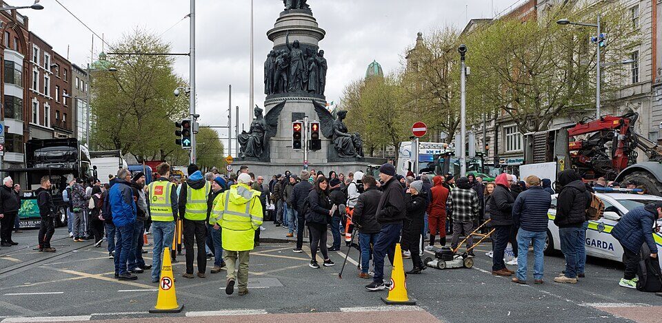 A wide-angle, eye-level shot of O'Connell Street in Dublin city centre, captured during a large-scale national fuel protest in April 2026.