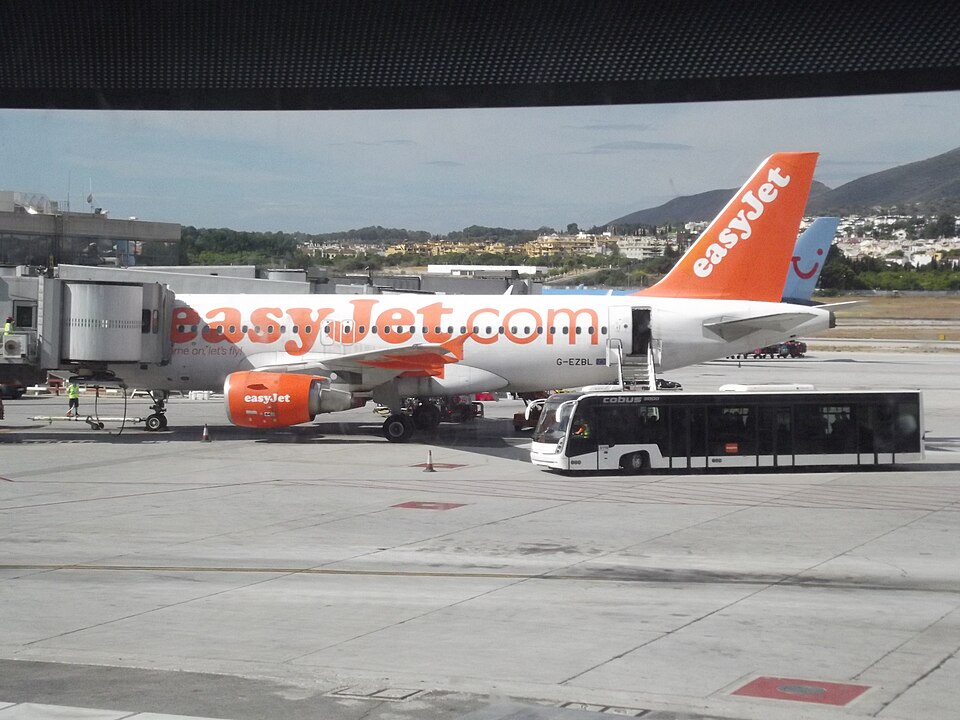 Easy Jet Airbus Airbus A319-111 parked in apron. Transport bus in front of the aircraft.