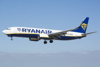 Ryanair Boeing 737-8AS EI-EBX at Leeds Bradford Airport, flying through the blue sky.