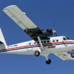 A Winair DHC-6 Twin Otter landing at Princess Juliana International Airport.