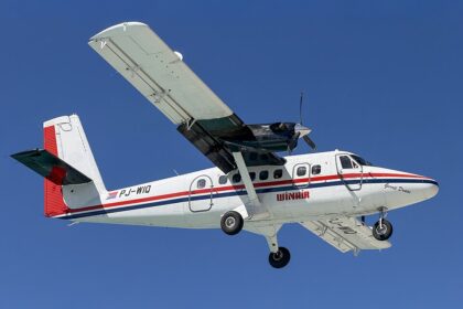 A Winair DHC-6 Twin Otter landing at Princess Juliana International Airport.