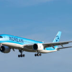 A350 Korean Air aircraft with light blue body and dark blue logo in flight.
