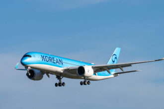 A350 Korean Air aircraft with light blue body and dark blue logo in flight.