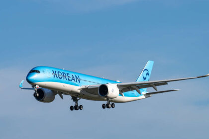 A350 Korean Air aircraft with light blue body and dark blue logo in flight.