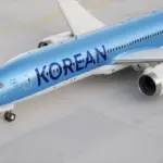 Image of a Korean Air aircraft, a sky blue colour with navy blue lettering and white wings and jets.
