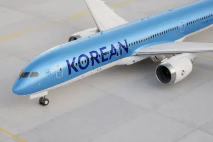 Image of a Korean Air aircraft, a sky blue colour with navy blue lettering and white wings and jets.