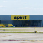 Spirit Airlines base at DTW, showing the terminal building with a large Spirit Airlines logo prominently displayed on the exterior