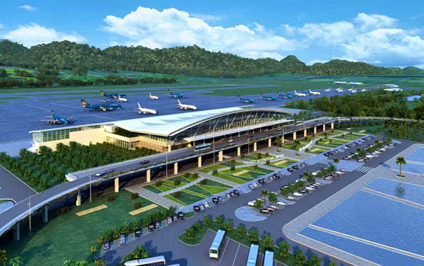 Aerial view of the Phu Quoc airport, with cars parked at the front of the airport and planes behind it