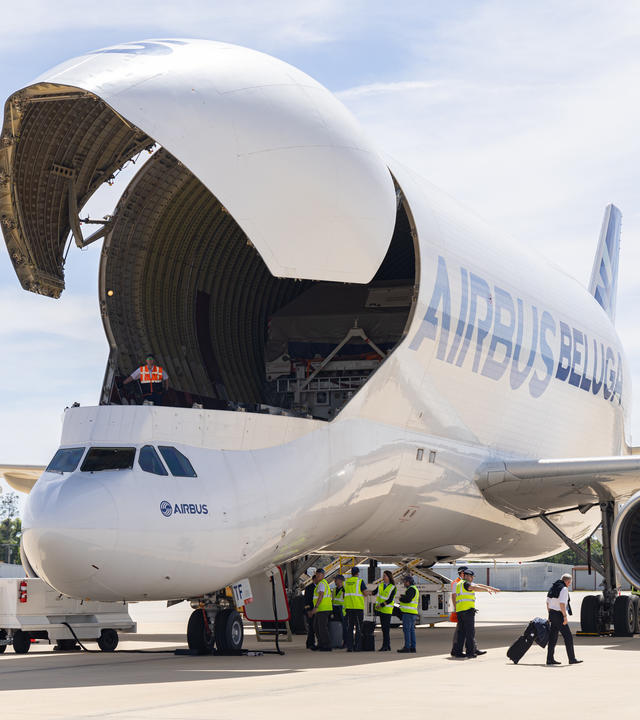 Front-side view of an Airbus Beluga Super Transporter cargo aircraft being loaded 